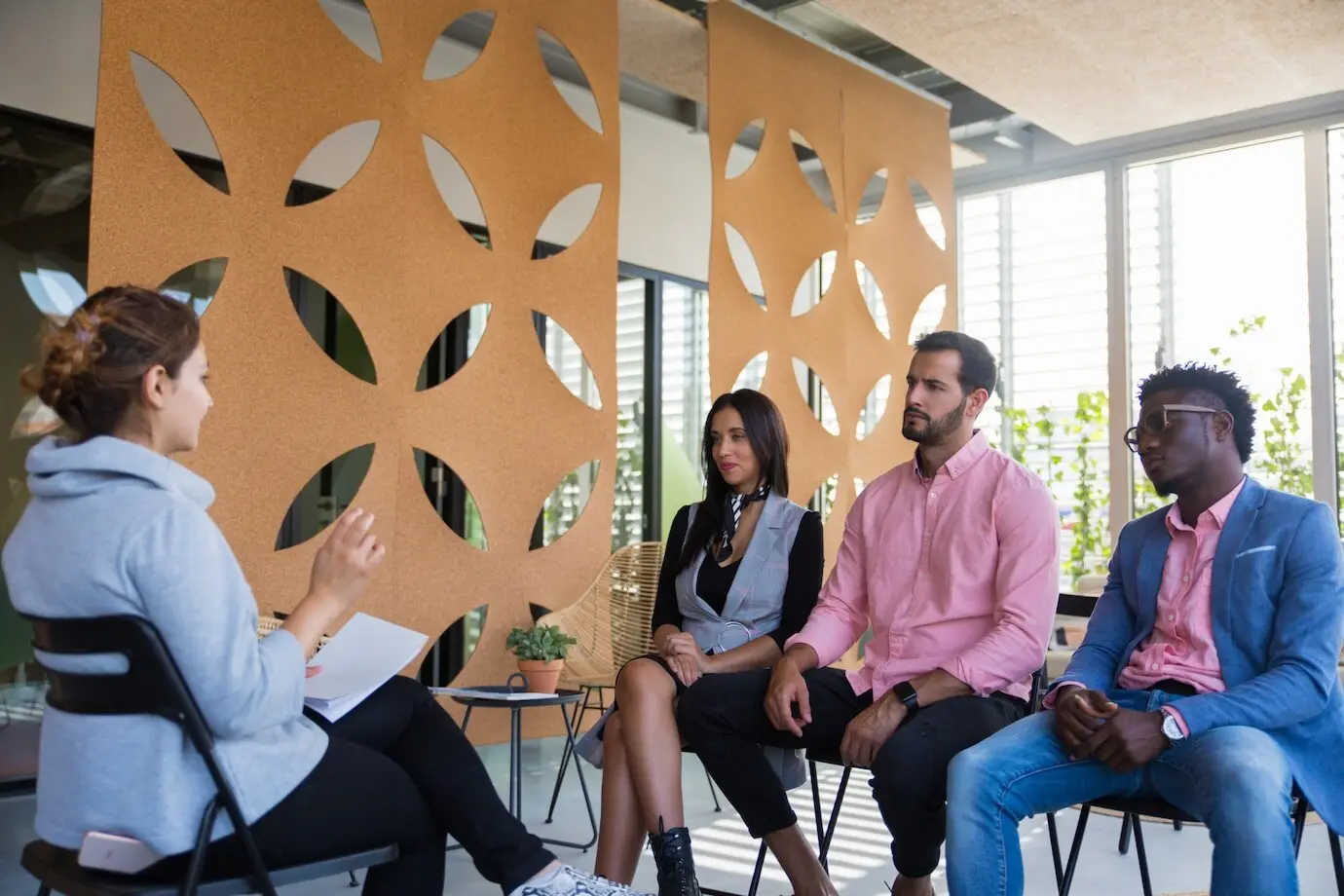 A diverse team of colleagues consulting a coach.