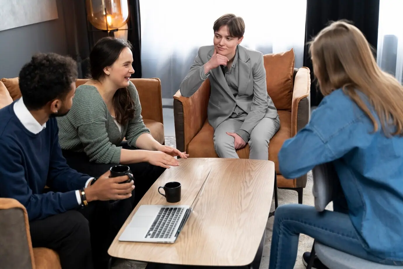 Trans person working in an office with colleagues