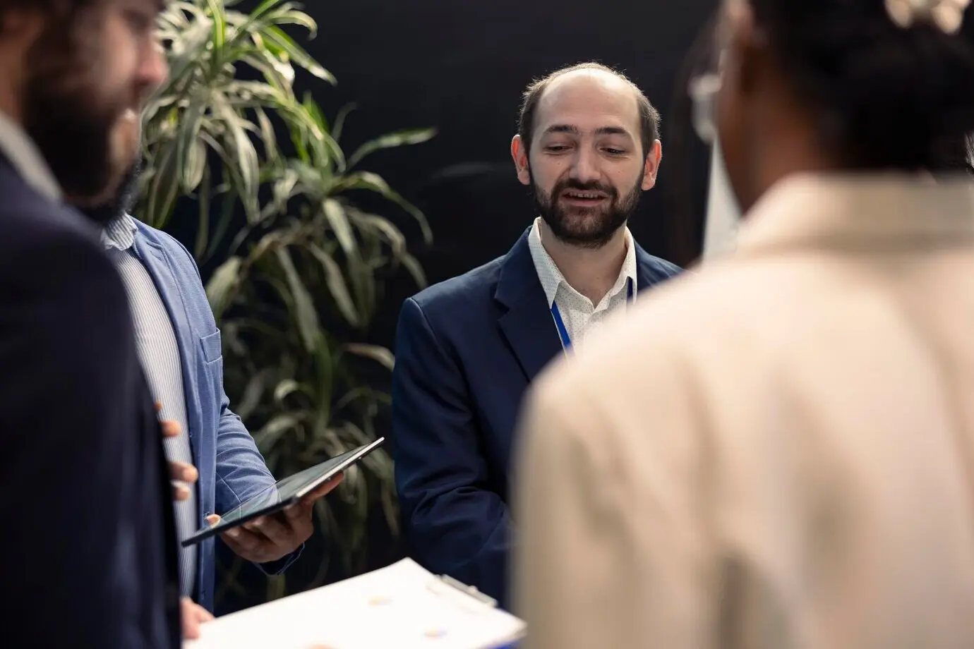 Corporate associates reviewing project details and schedules at a conference.